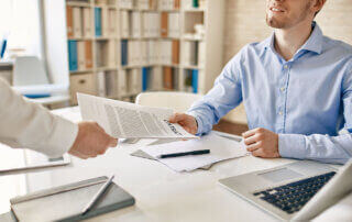 Two men exchanging an IT Support Contract with SLA