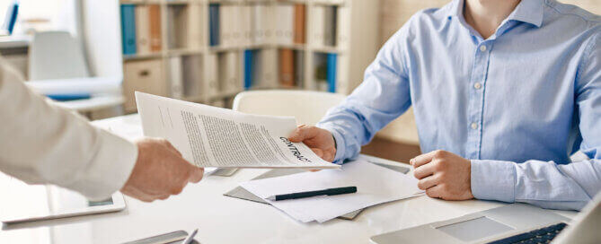 Two men exchanging an IT Support Contract with SLA